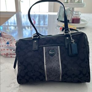 Chic Black Handbag with Blue Tag